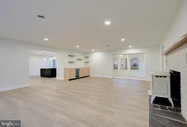 a kitchen with stainless steel appliances a stove a sink a microwave a center island and cabinets