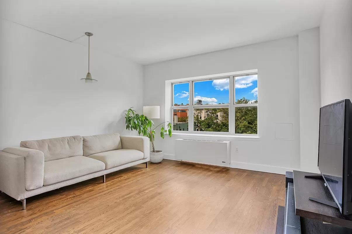 362 St Nicholas Avenue, Unit 9A Manhattan, NY 10027 - Photo 2 of 12 a living room with furniture and a flat screen tv