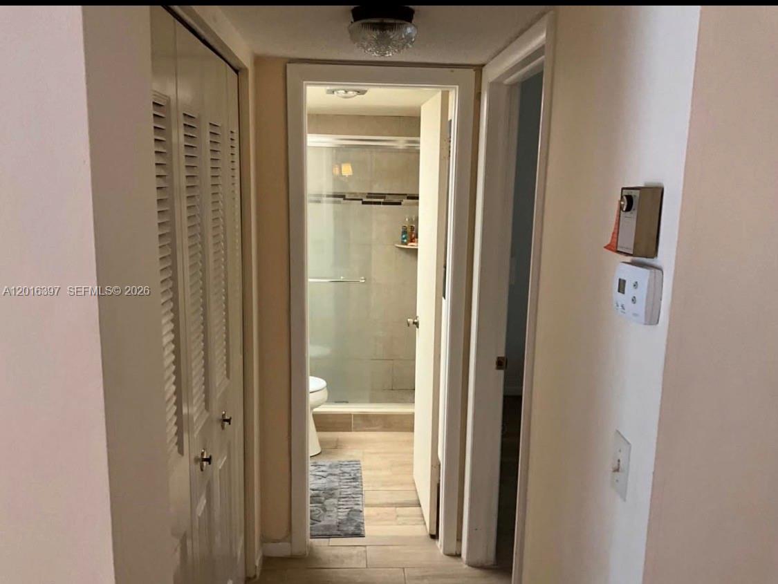 151 Berkley Road, Unit 303 Hollywood, FL 33024 - Photo 7 of 11 a view of a bathroom with a glass door