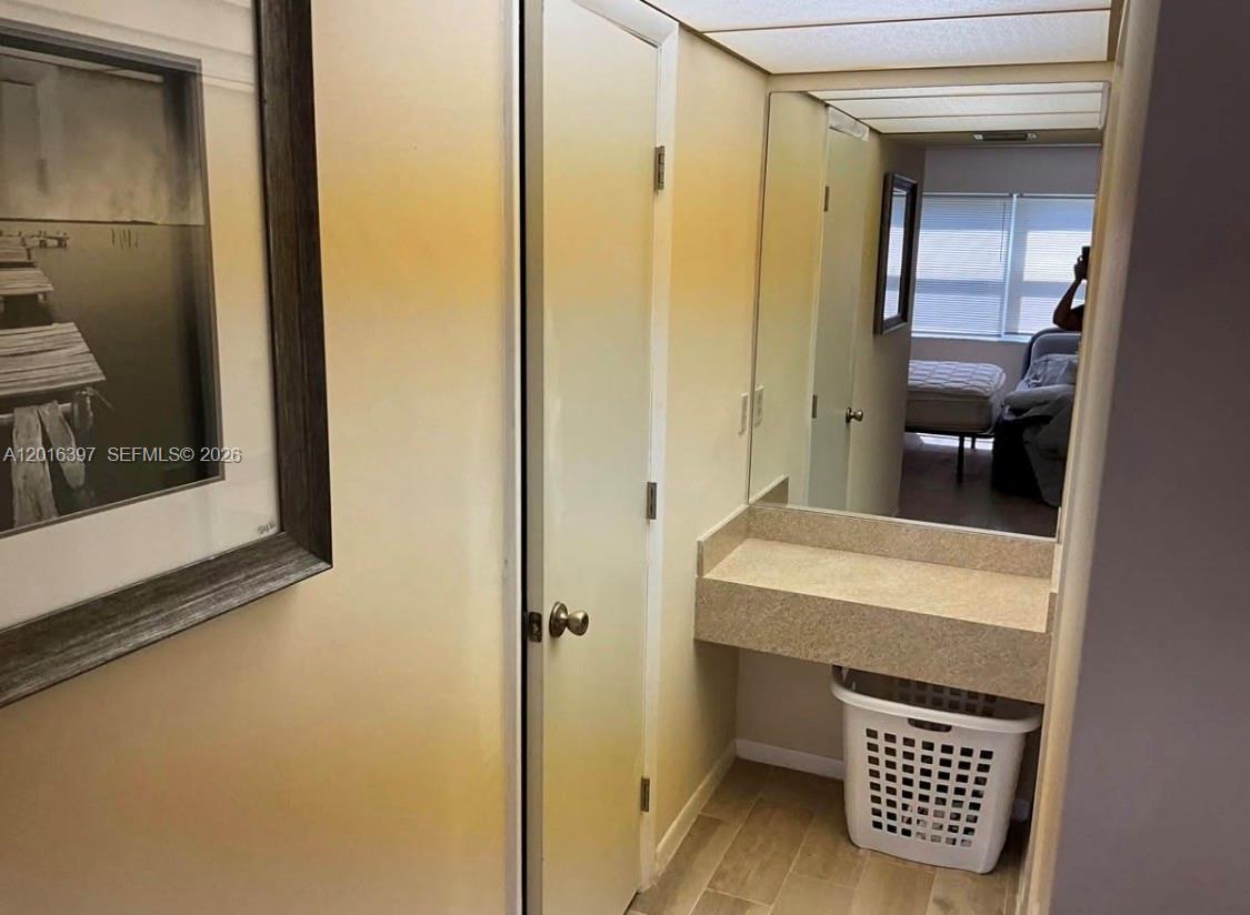 151 Berkley Road, Unit 303 Hollywood, FL 33024 - Photo 9 of 11 a bathroom with a sink and a mirror