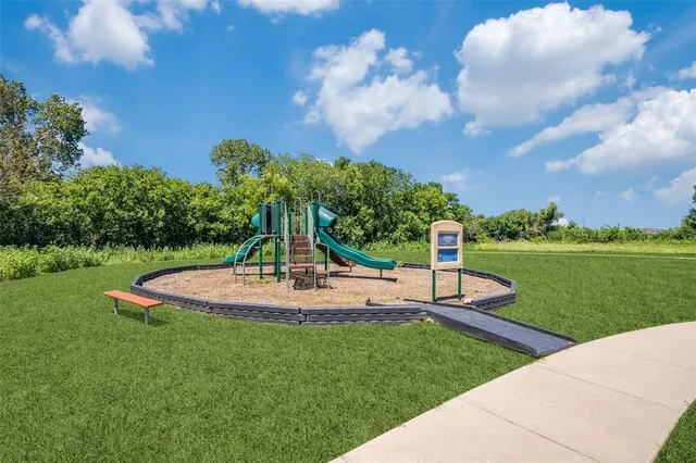 a view of a garden with lawn chairs