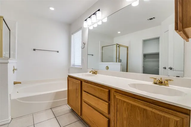 a bathroom with a tub sink and mirror