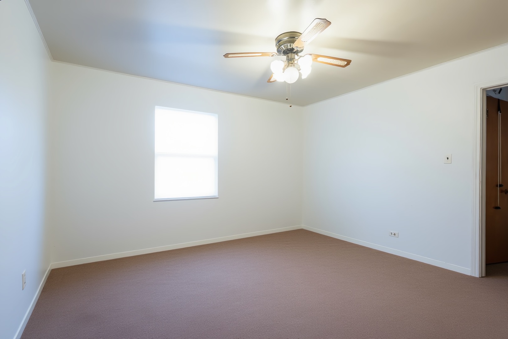 1744 Wesley Avenue Evanston, IL 60201 - Photo 8 of 31 an empty room with a chandelier fan and windows