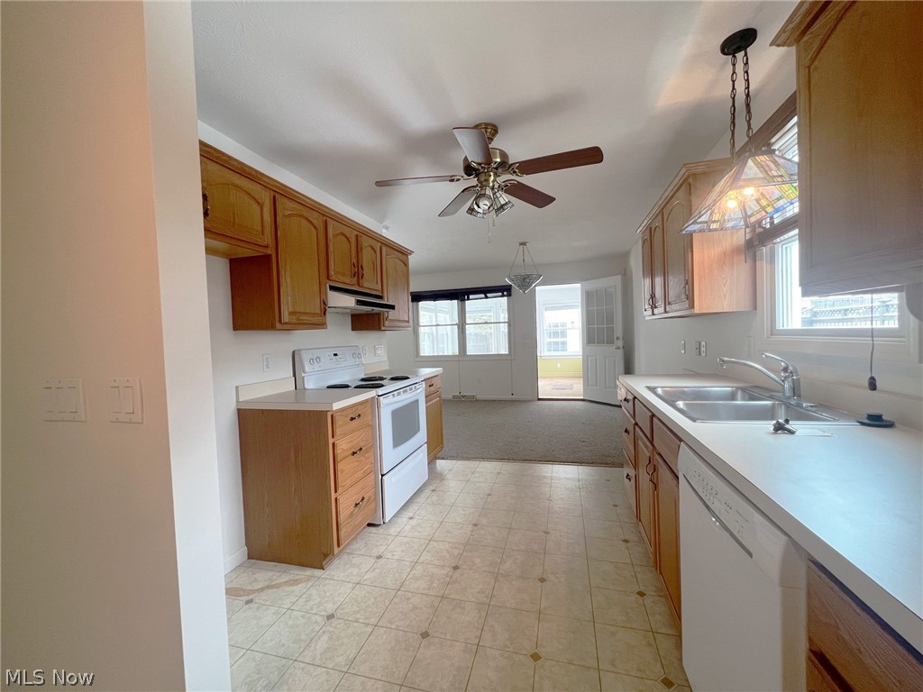 5203 Ridgeland Street Lorain, OH 44055 - Photo 11 of 39 Kitchen with white appliances, ceiling fan, hanging light fixtures, and sink