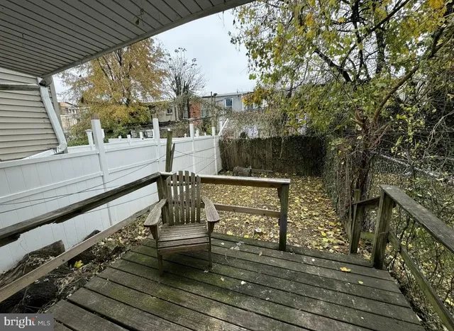 a view of balcony with wooden floor and bench