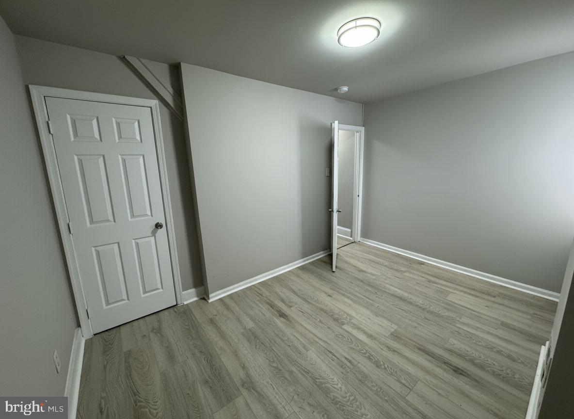 70 East Walnut Lane Philadelphia, PA 19144 - Photo 6 of 11 an empty room with wooden floor and windows