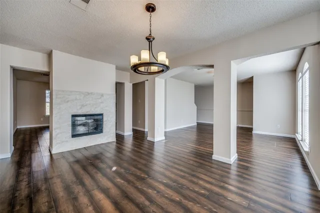 a view of a hallway with wooden floor and a fireplace
