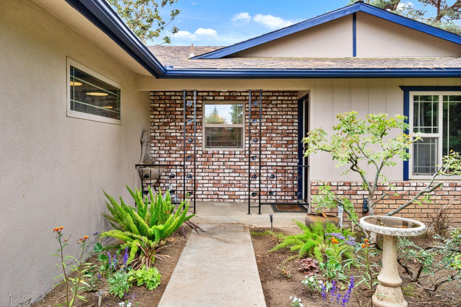 918 East Griffith Way Fresno, CA 93704 - Photo 12 of 21 a front view of a house with a garden