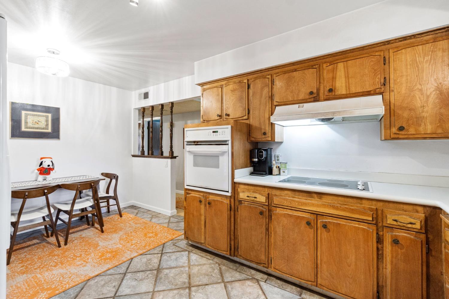 918 East Griffith Way Fresno, CA 93704 - Photo 15 of 21 a kitchen with cabinets and chairs