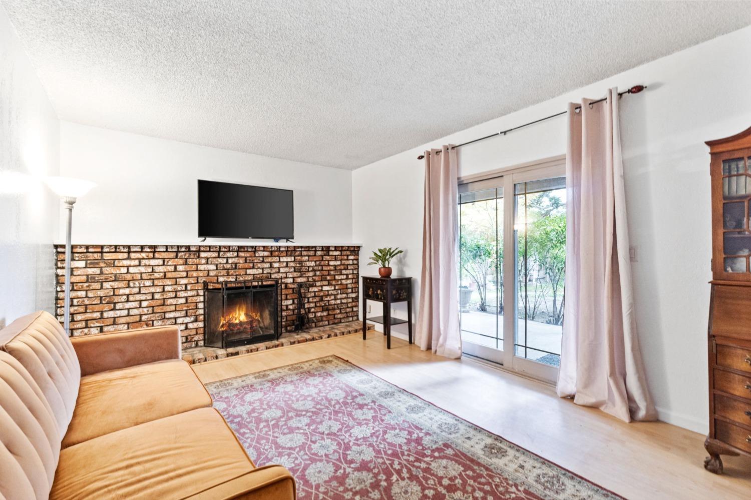 918 East Griffith Way Fresno, CA 93704 - Photo 16 of 21 a living room with furniture and a fireplace