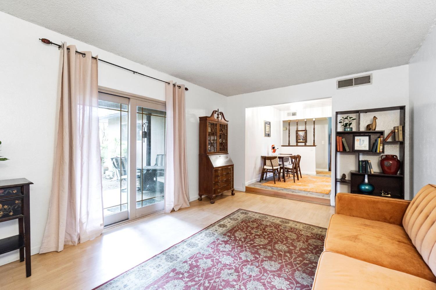 918 East Griffith Way Fresno, CA 93704 - Photo 17 of 21 a living room with furniture and a wooden floor