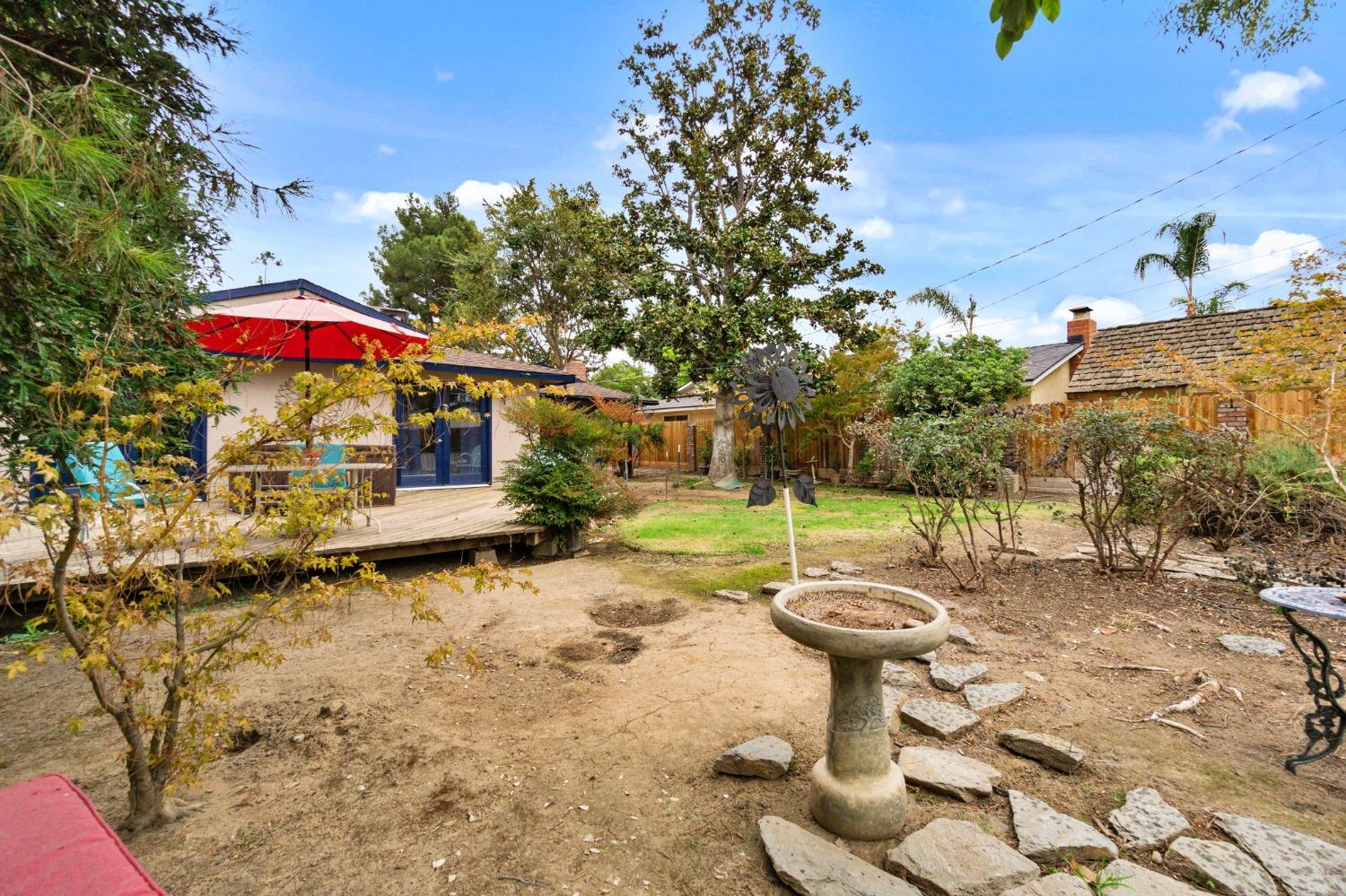 918 East Griffith Way Fresno, CA 93704 - Photo 18 of 21 a view of a patio with table and chairs under an umbrella