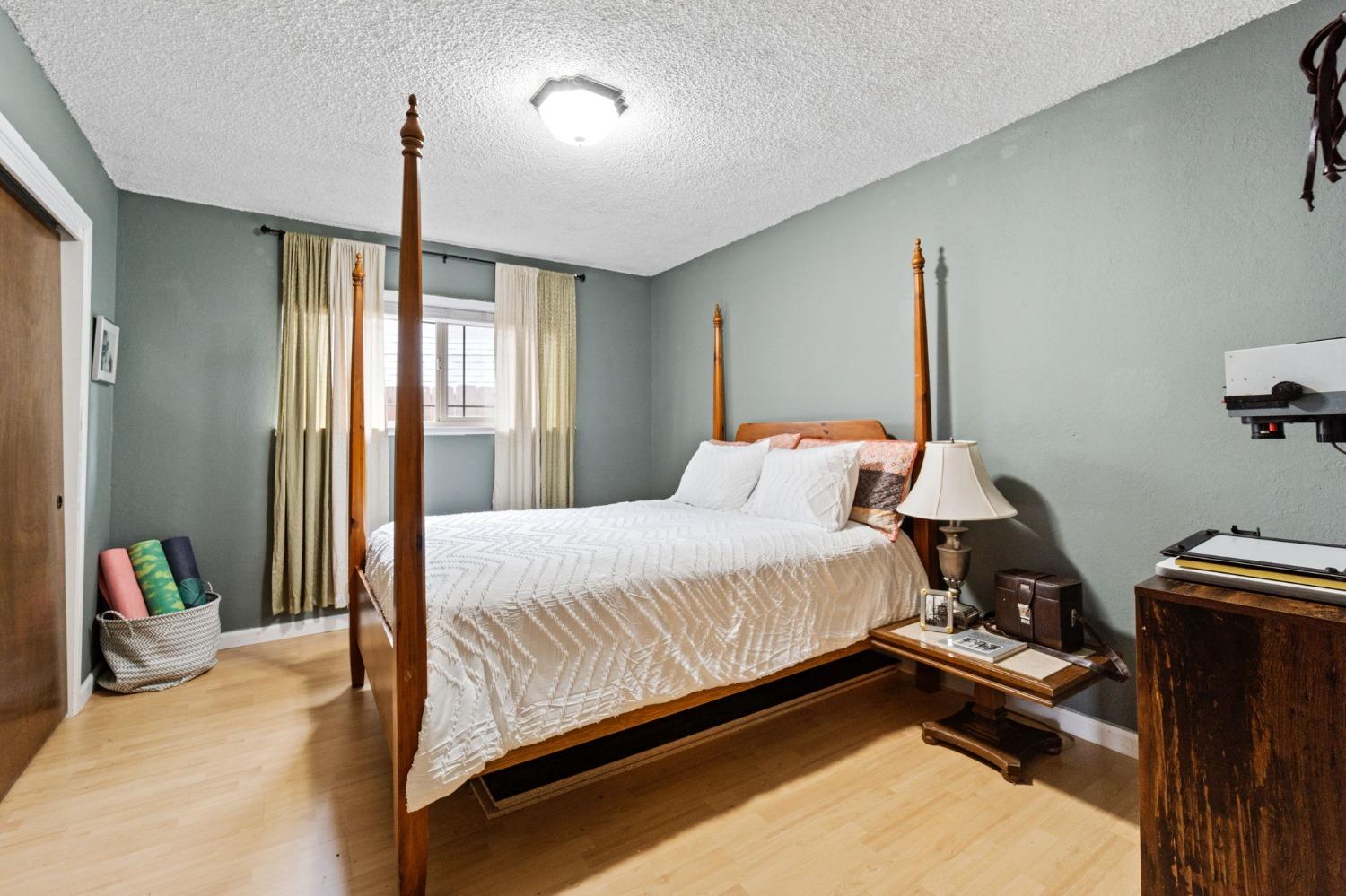 918 East Griffith Way Fresno, CA 93704 - Photo 6 of 21 a bedroom with a bed and a window