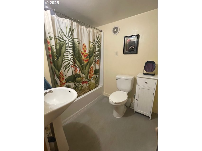 239 D Street Springfield, OR 97477 - Photo 8 of 14 a bathroom with a toilet sink and mirror