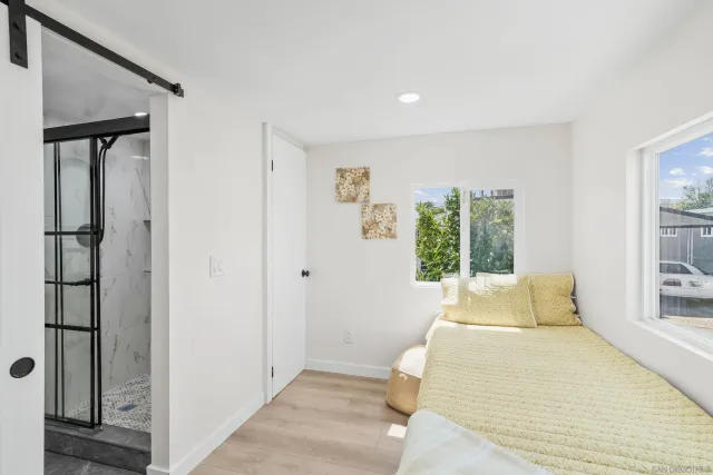 a bedroom with a bed and a window