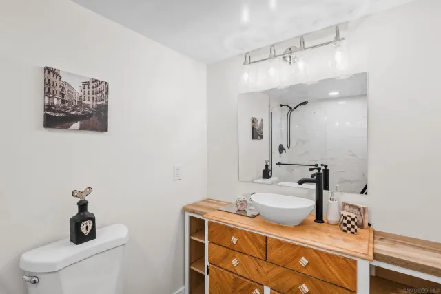a bathroom with a sink toilet and mirror