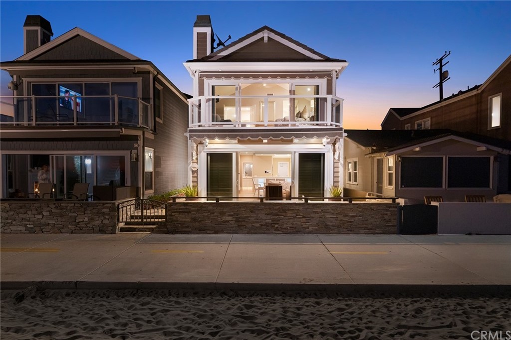2712 West Oceanfront Newport Beach, CA 92663 - Photo 1 of 32 a front view of a house with a yard