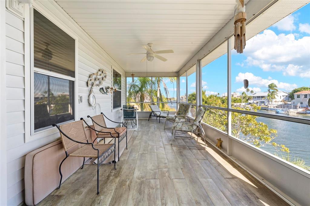 Undisclosed Address Hernando Beach, FL 34607 - Photo 69 of 90 a view of a balcony with chairs and wooden floor