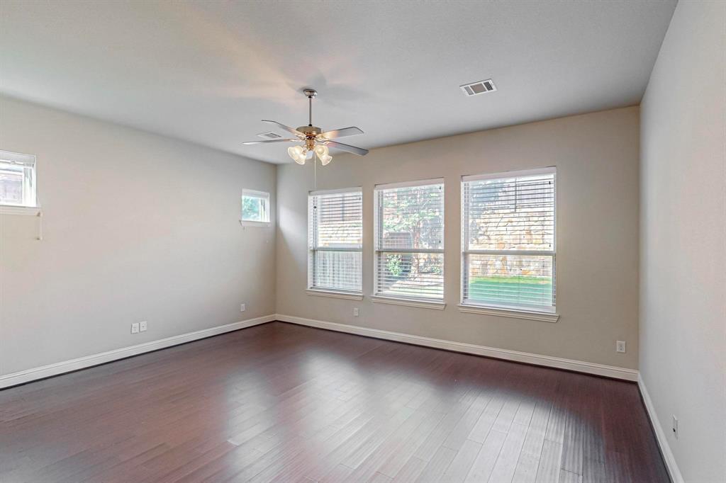 6723 Capistrano Street Irving, TX 75039 - Photo 16 of 40 an empty room with wooden floor and windows