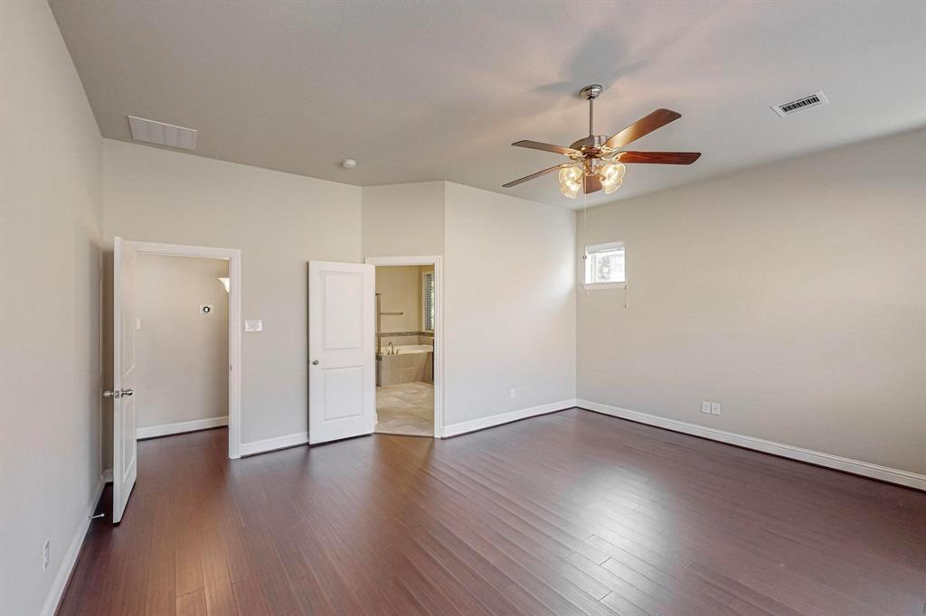 6723 Capistrano Street Irving, TX 75039 - Photo 17 of 40 a view of an empty room with a window and wooden floor