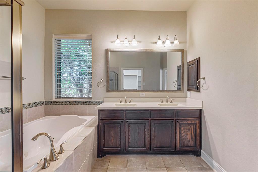 6723 Capistrano Street Irving, TX 75039 - Photo 19 of 40 a bathroom with a tub sink and mirror