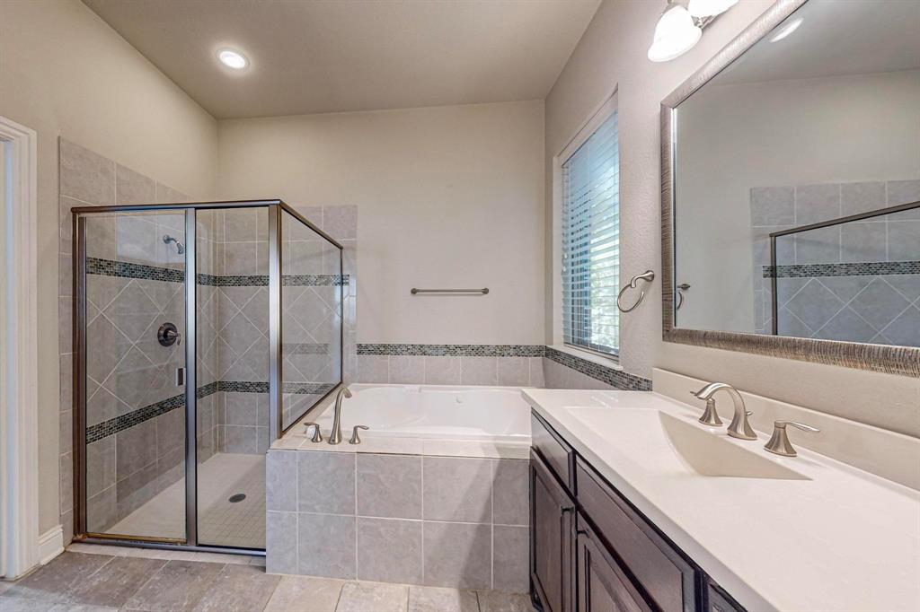 6723 Capistrano Street Irving, TX 75039 - Photo 20 of 40 a bathroom with a tub sink and mirror