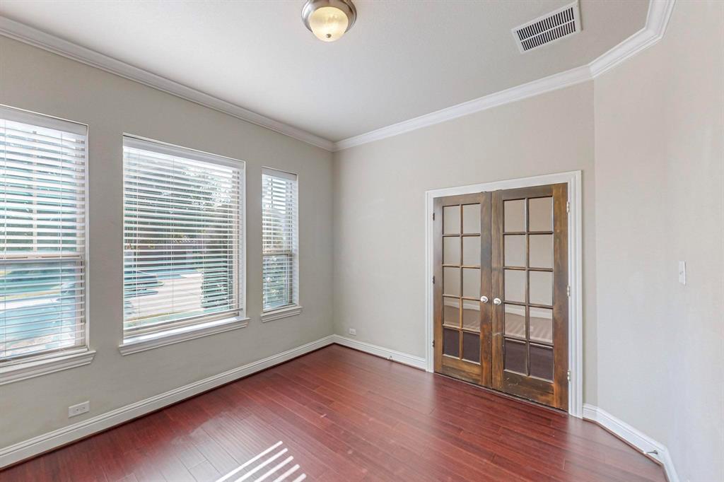 6723 Capistrano Street Irving, TX 75039 - Photo 27 of 40 an empty room with wooden floor and windows