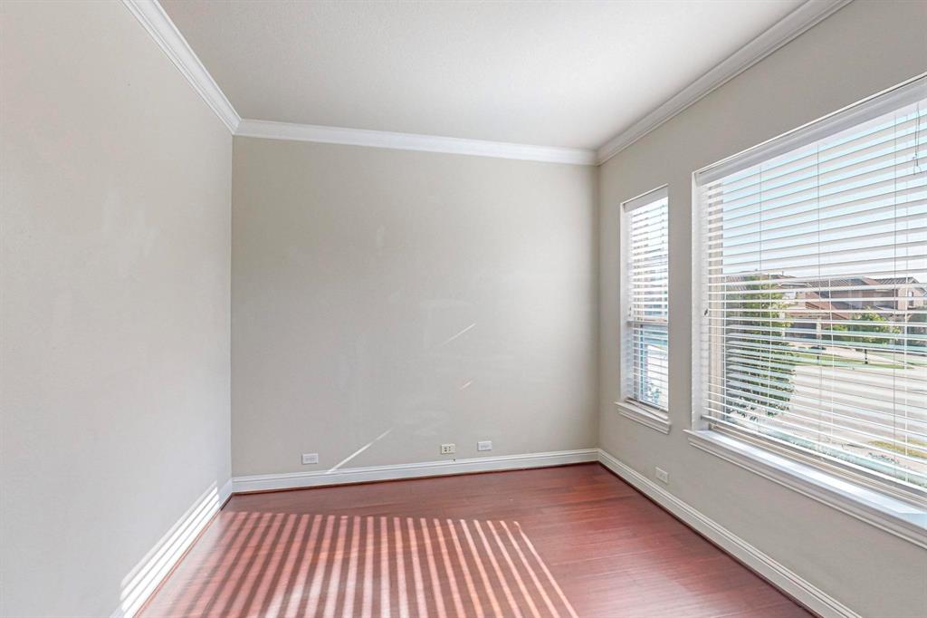 6723 Capistrano Street Irving, TX 75039 - Photo 28 of 40 an empty room with wooden floor and windows