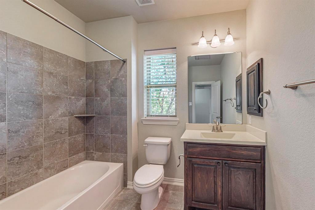 6723 Capistrano Street Irving, TX 75039 - Photo 34 of 40 a bathroom with a sink a toilet and shower