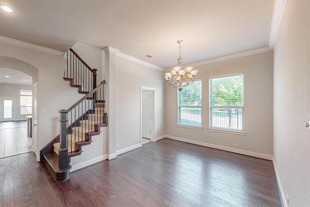 6723 Capistrano Street Irving, TX 75039 - Photo 36 of 40 a view of an empty room with wooden floor and a window