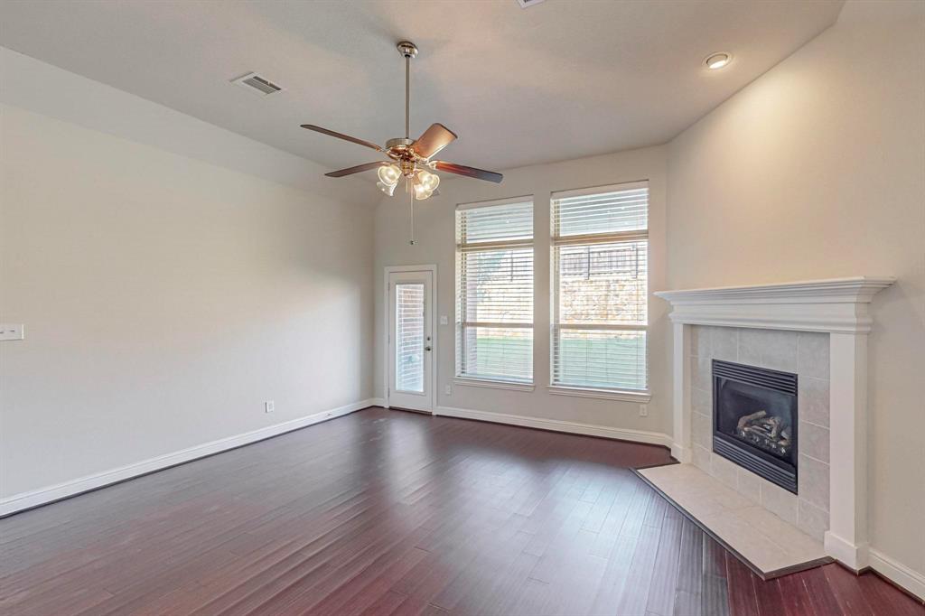 6723 Capistrano Street Irving, TX 75039 - Photo 4 of 40 a view of an empty room with a fireplace and a window