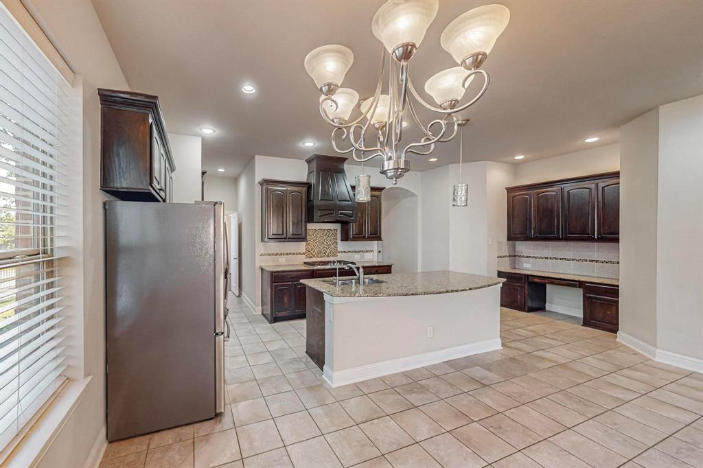 6723 Capistrano Street Irving, TX 75039 - Photo 7 of 40 a kitchen with stainless steel appliances granite countertop a refrigerator and a stove top oven