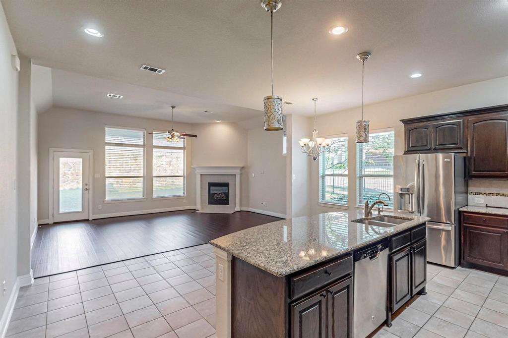 6723 Capistrano Street Irving, TX 75039 - Photo 10 of 40 a kitchen with stainless steel appliances granite countertop a sink stove and refrigerator