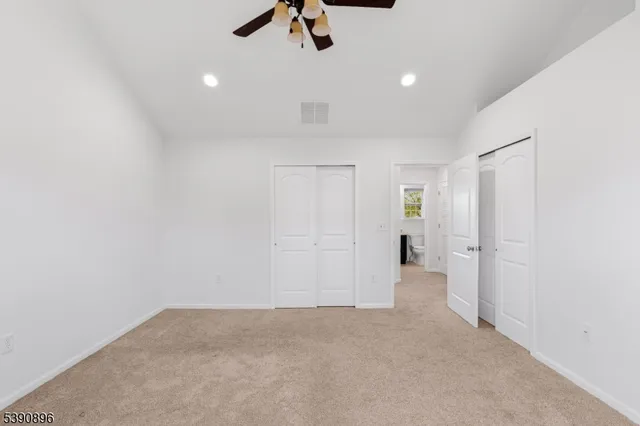 an empty room with view of bathroom