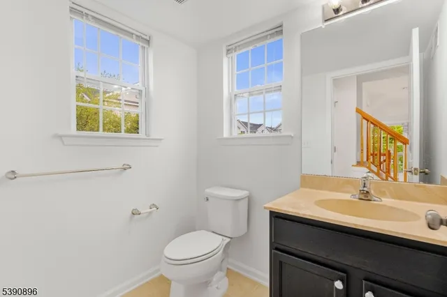 a bathroom with a sink a toilet and a window