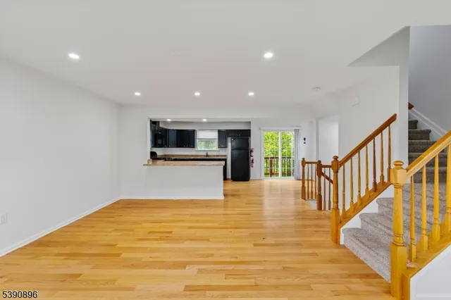 a view of kitchen with wooden floor and electronic appliances
