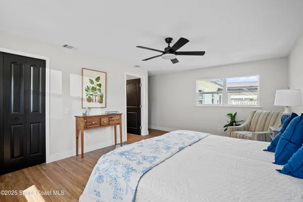 a bedroom with a bed dresser and a window