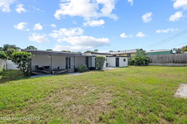 a front view of house with yard and outdoor seating