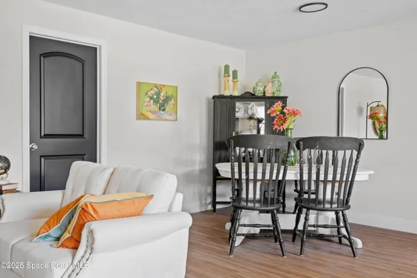 a dining room with furniture and wooden floor