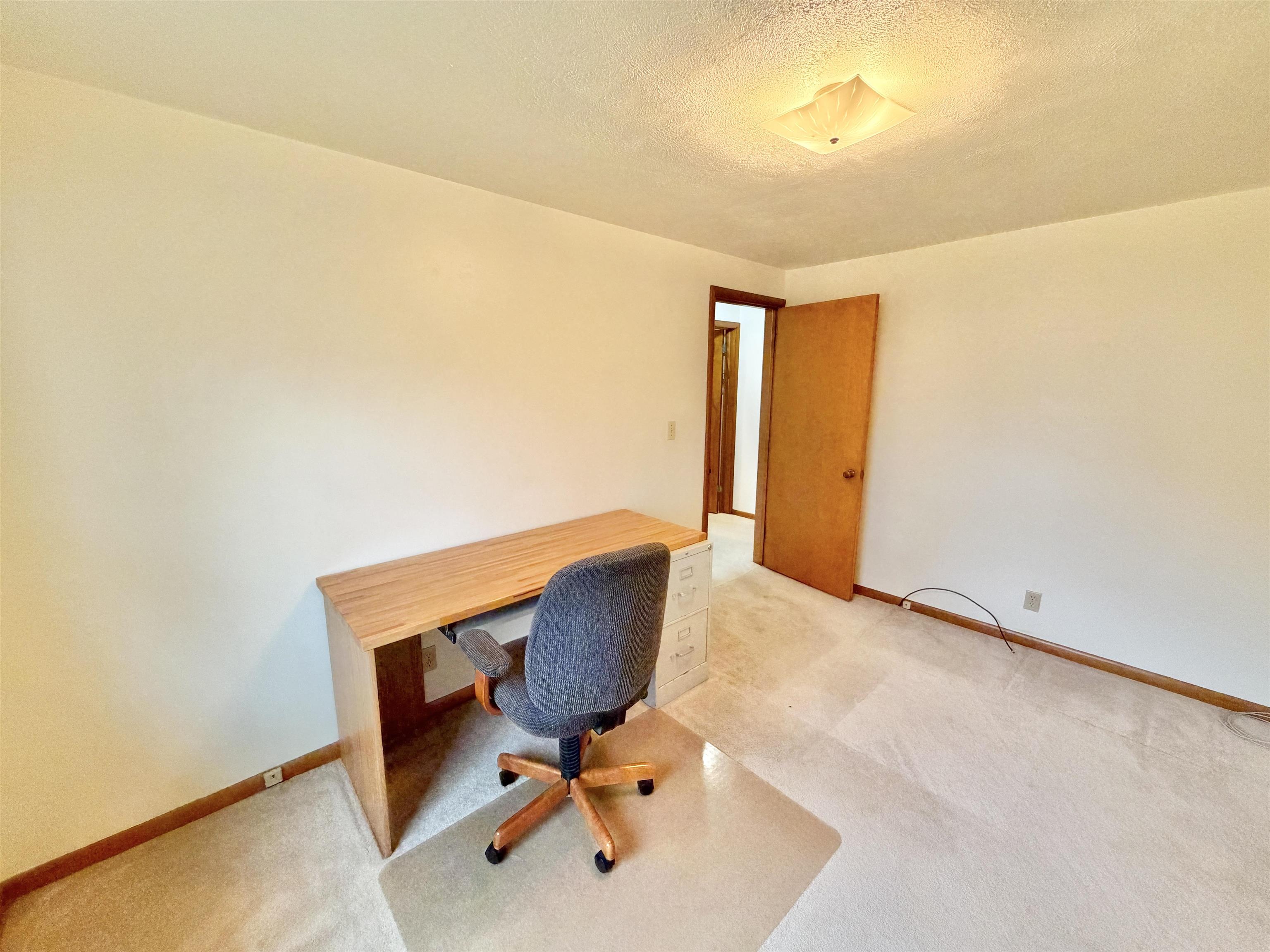 305 West Pershing Street Stillman Valley, IL 61084 - Photo 12 of 37 a view of workspace with chair and wooden floor