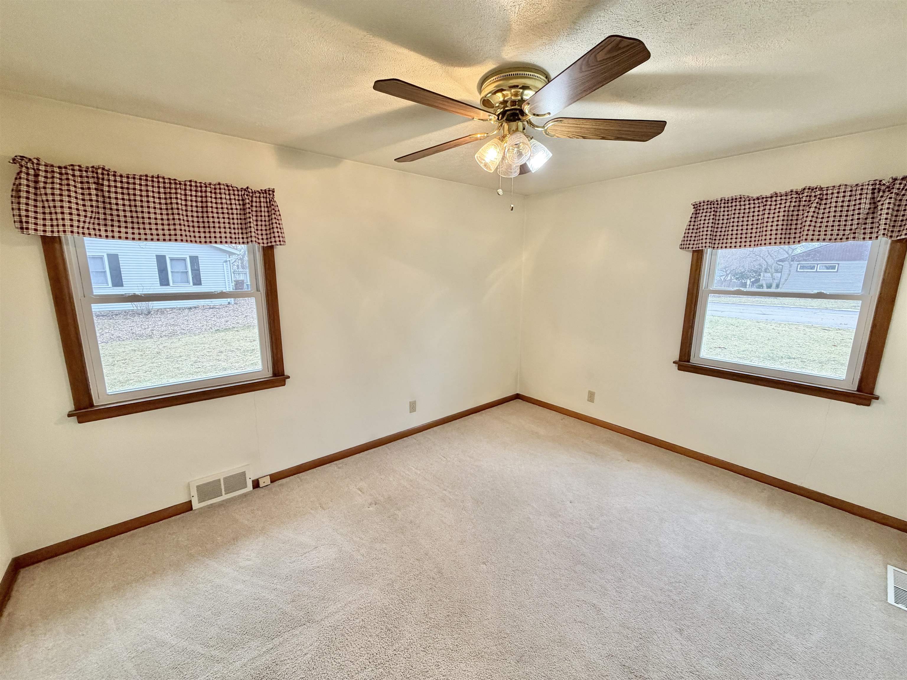 305 West Pershing Street Stillman Valley, IL 61084 - Photo 13 of 37 an empty room with windows and fan