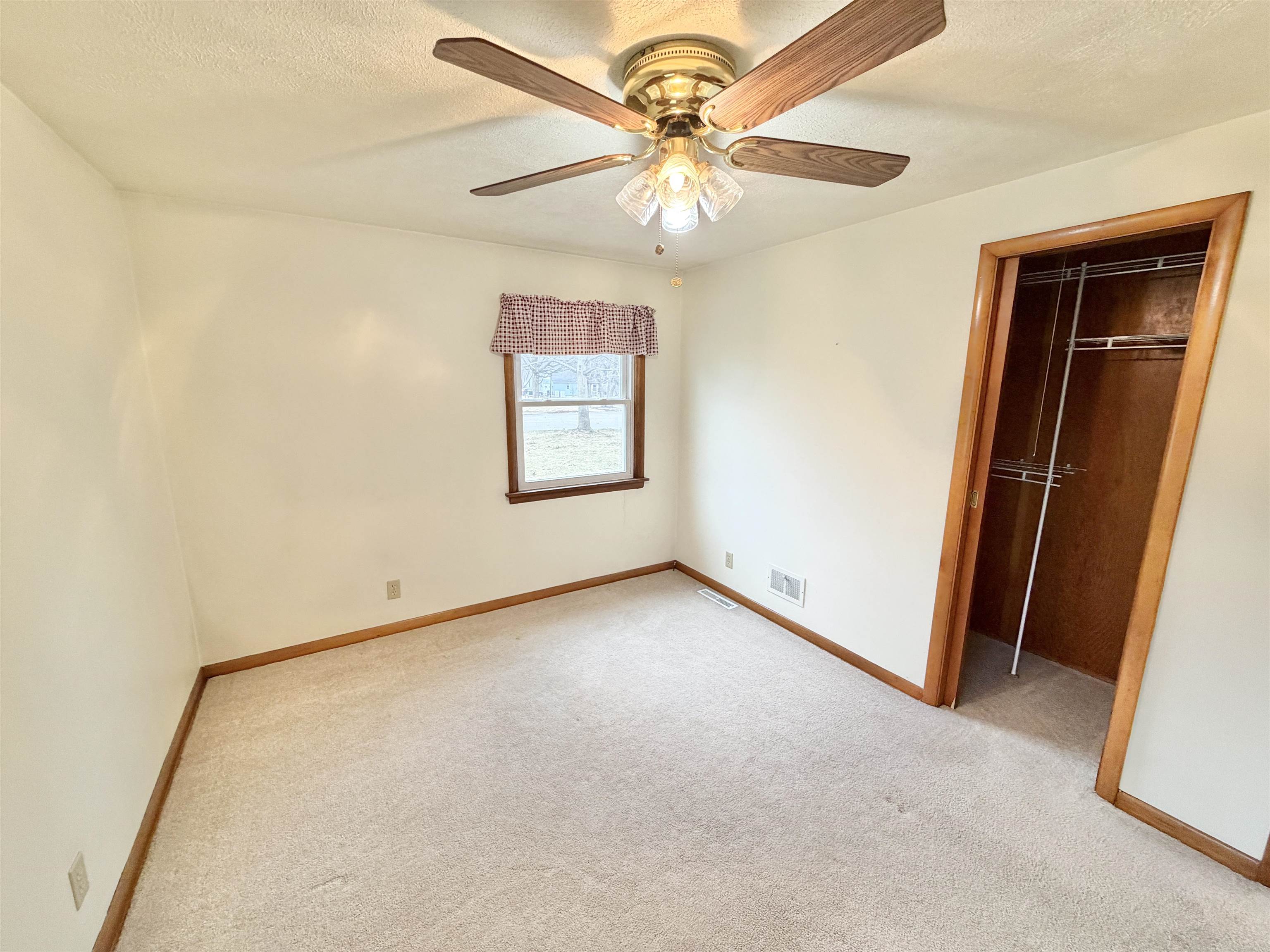 305 West Pershing Street Stillman Valley, IL 61084 - Photo 14 of 37 an empty room with a chandelier fan and windows