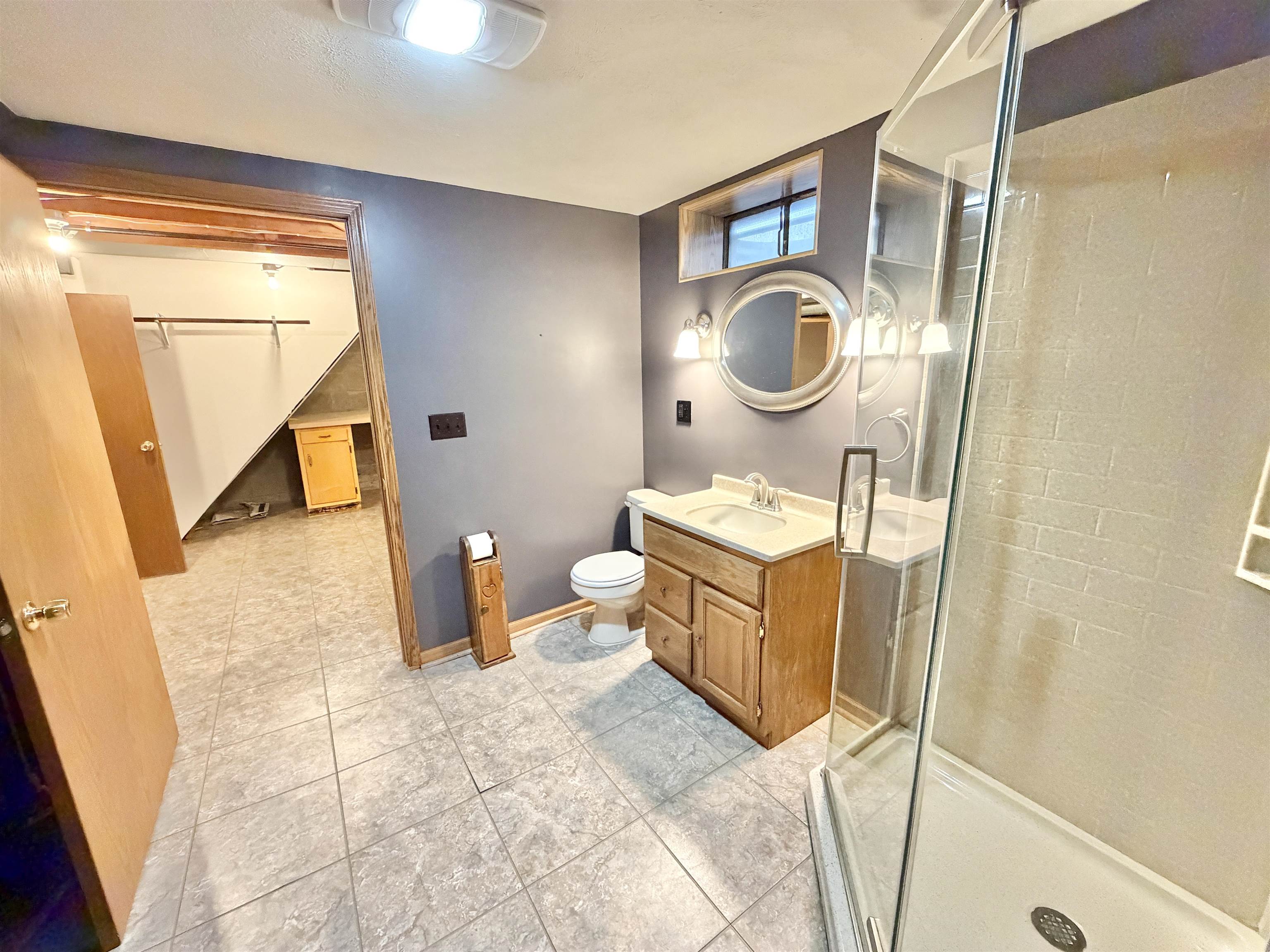 305 West Pershing Street Stillman Valley, IL 61084 - Photo 25 of 37 a bathroom with a sink a toilet and a mirror