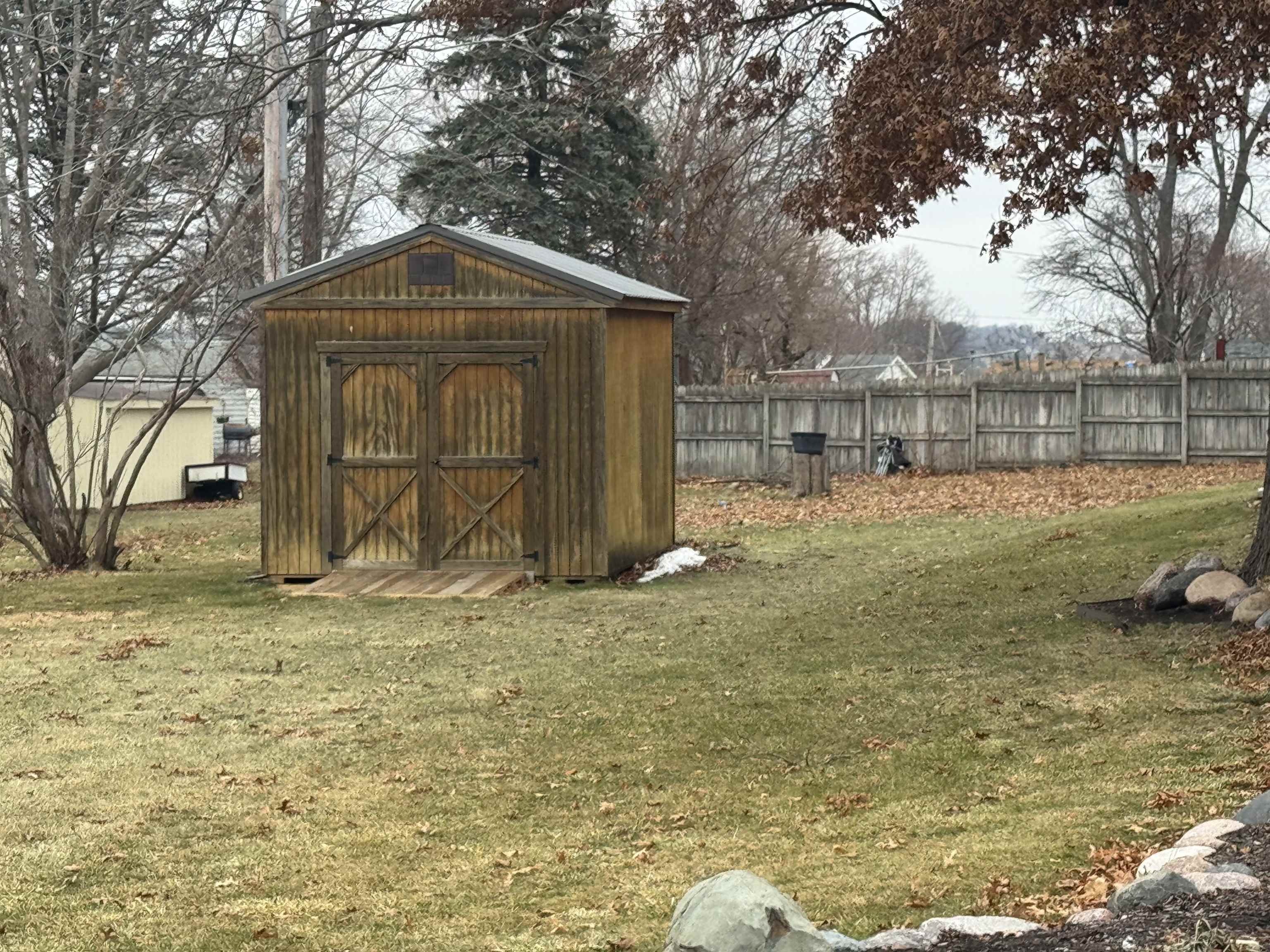 305 West Pershing Street Stillman Valley, IL 61084 - Photo 32 of 37 a view of a wooden house with a yard
