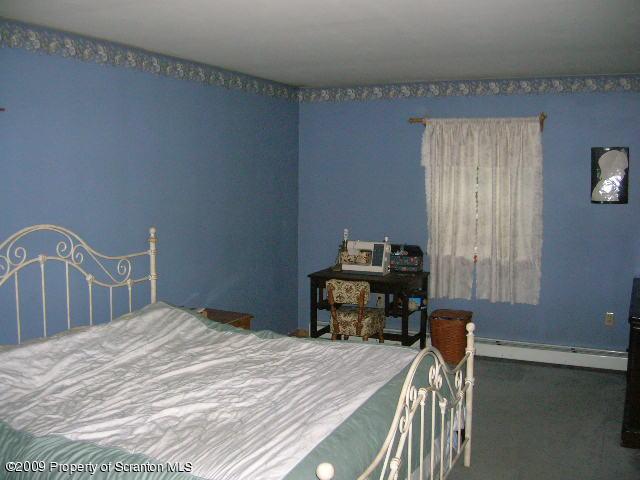 284 Long Mountain Road Effort, PA 18330 - Photo 14 of 20 a bedroom with a bed table and a chair