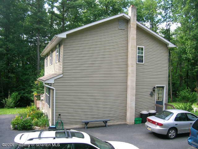 284 Long Mountain Road Effort, PA 18330 - Photo 3 of 20 a white house covered with tall trees
