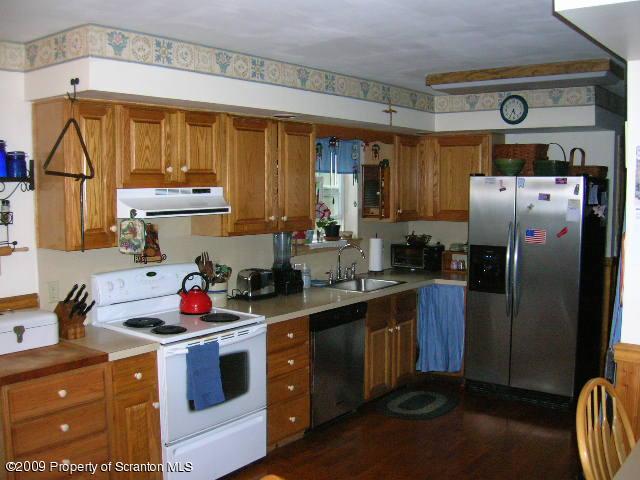284 Long Mountain Road Effort, PA 18330 - Photo 7 of 20 a kitchen with stainless steel appliances a stove a refrigerator a sink and cabinets