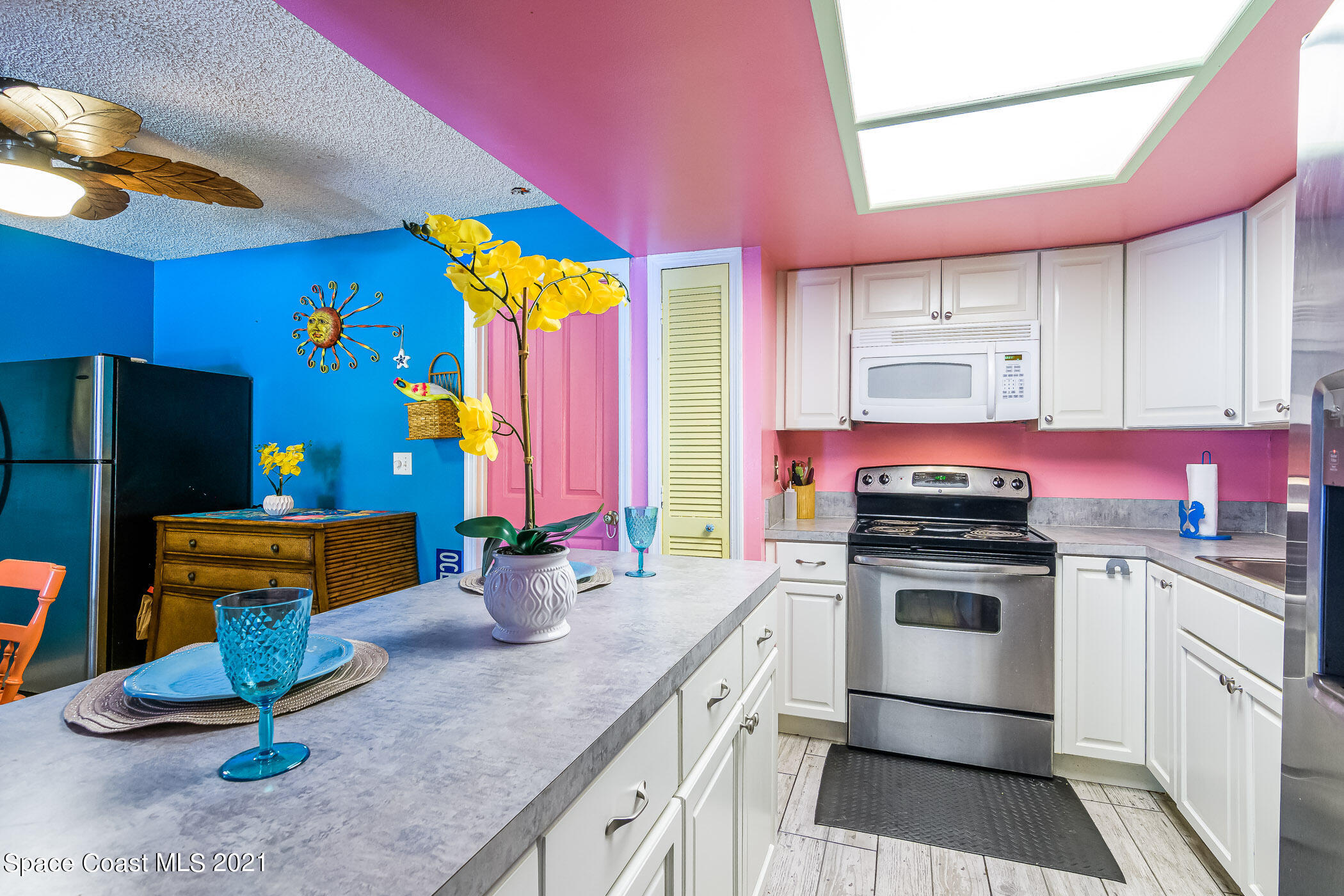 1100 Gary Hunt Road, Unit 1D Cocoa, FL 32926 - Photo 14 of 24 a kitchen with stainless steel appliances granite countertop a stove a sink and a refrigerator