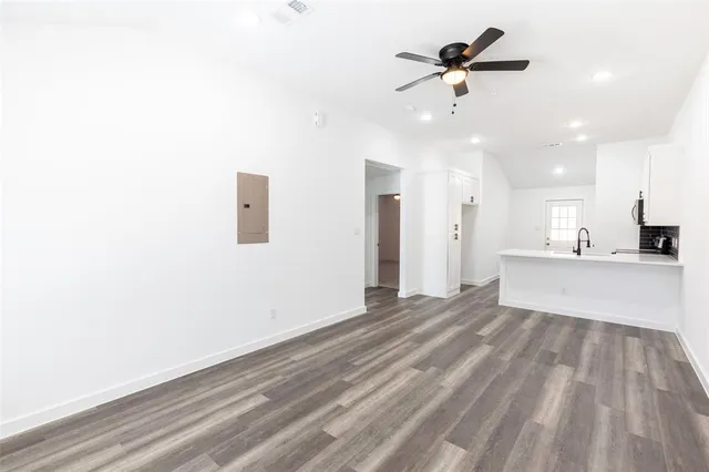 a view of an empty room with a ceiling fan