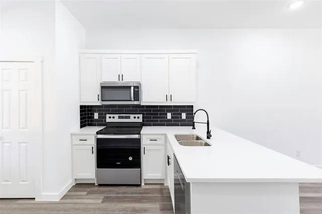 a kitchen with a stove and a microwave